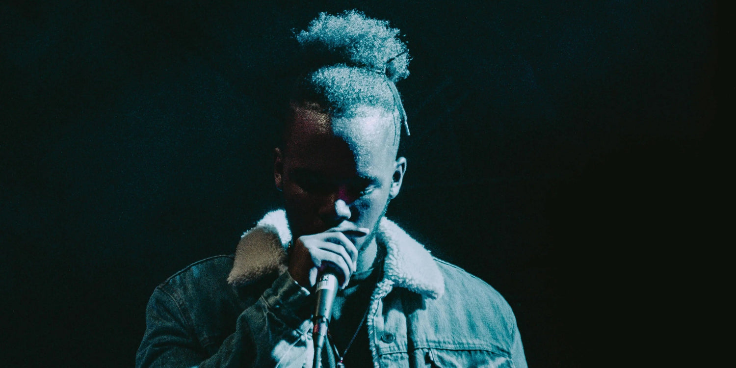 A musician using the microphone at a concert