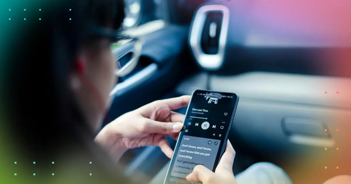 A girl holding a phone with Spotify on the display