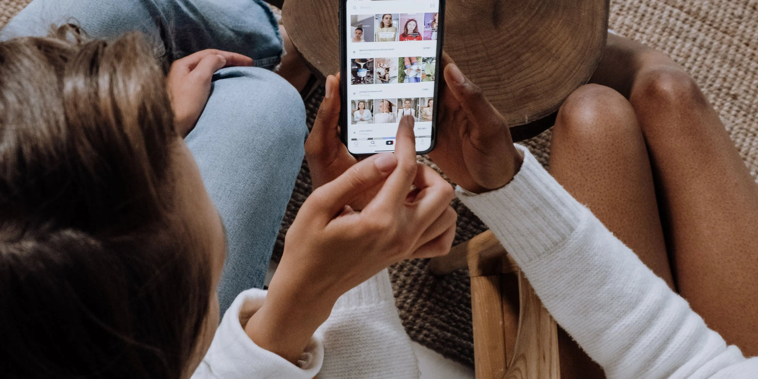 Two girls are watching TikTok videos on an iPhone